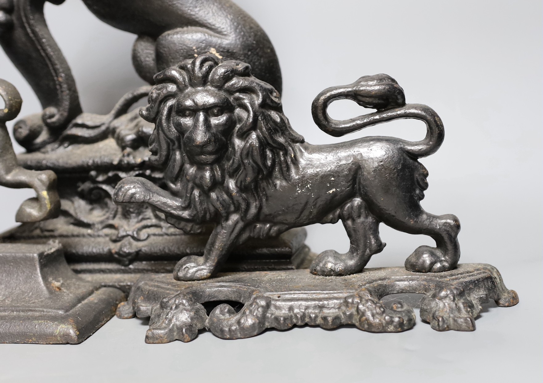 Four cast iron ‘lion’ door stops, 39cm